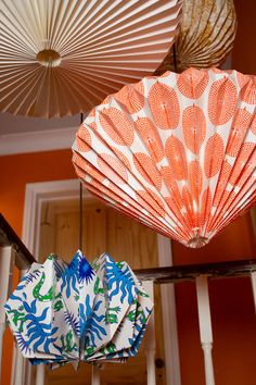 three paper fans are hanging from the ceiling