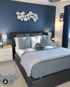 a bedroom with blue walls and white bedding