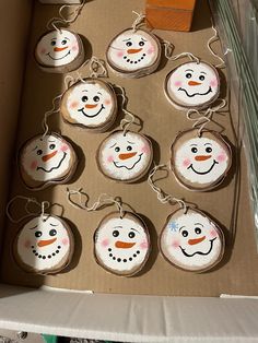 a cardboard box filled with snowman ornaments