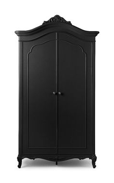 a black armoire with an ornate design on the top and bottom panel, in front of a white background