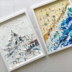 two pieces of art are displayed on the wall, one is made out of paper and the other has an image of people skiing