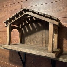 a wooden bird house on top of a shelf