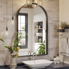 a bathroom sink sitting under a large mirror