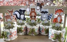 several rolls of toilet paper decorated with woodland animals and deers are on the table