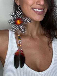 Double strand beaded big flower feather earring, with trade beads , tear drop beads, acai beads and natural feathers.Sold Individually Beaded Feather, Earring Long, Long Statement Earrings, Eco Jewelry, Bold Earrings, Feather Jewelry, Ethnic Earrings, Drop Beads, Trade Beads