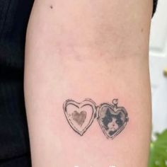 two heart shaped tattoos on the back of a woman's left arm, one with an image of a dog and another with a cat