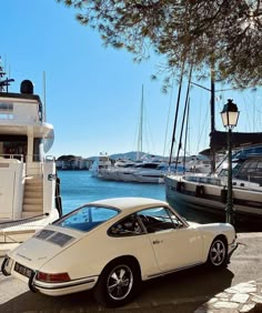 a white car parked in front of a boat