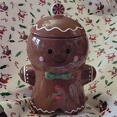 a ceramic gingerbread cookie jar with a green bow tie