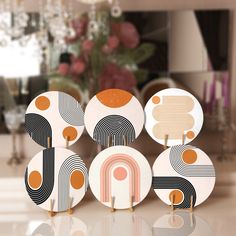 an assortment of decorative plates on display in a room with flowers and chandelier