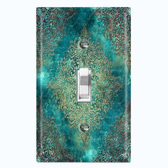 a light switch cover with an intricate design on the front and sides, in teal green