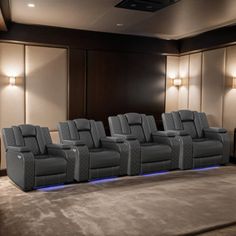 a row of grey chairs sitting next to each other in front of a projector screen