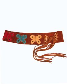 Multi-colored butterfly overlays and studs add a cute, boho touch to this suede leather tie belt. The contour shape makes it easy to wear loosely around the hips or use to cinch in the waist with the adjustable ties! 3.25" width Size S/M 32"-36" 20" tie length Genuine Leather- Tan Suede, multi colored butterflies Copper Studs Made in the USA **Vintage Sample, from early 2000's, a few tiny scratches on suede Adjustable Corset Belt With Belt Loops For Festivals, Adjustable Corset Belt For Festivals, Brown Leather Corset Belt For Festivals, Adjustable Brown Belt For Festival, Adjustable Brown Belts For Festival, Bohemian Brown Belt For Festival, Vintage Brown Corset Belt For Festivals, 70s Belts, 2000s Belt