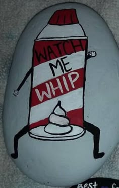 a painted rock with the words watch me whip on it and a cartoon figure holding a cup