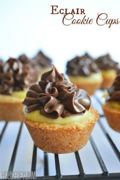 cupcakes with chocolate frosting and sprinkles are on a cooling rack