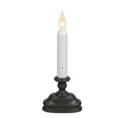 a white candle is lit on a black stand