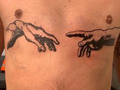 the creation of man's hands is depicted on his chest, while another hand reaches out to touch him