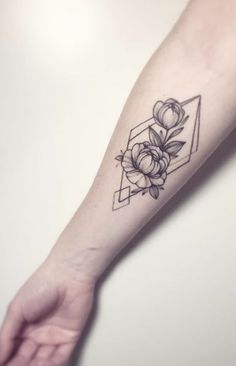 a woman's arm with a flower tattoo on the left side of her arm