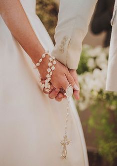 the bride and groom are holding hands