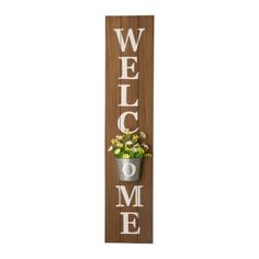 a wooden sign that says welcome to me with flowers in a pot on the front