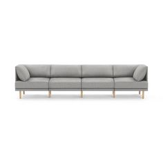 a grey couch with wooden legs on a white background