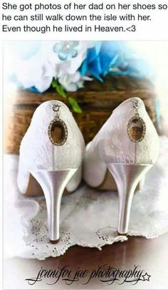 a pair of white high heels sitting on top of a table