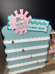 "Our display allows you to show off all of gorgeous charms at your vendor events or shows. It holds 50 charms with a 6mm jump ring. Place your logo or a charming phrase at the pinnacle of this, measuring 12 inches in width and 14-15 inches in height. The dimensions are taken prior to the attachment of the flat acrylic base. Upon addition of the base, the sign will extend slightly in both width and height. Please send me a message on Etsy if you have any questions before ordering or are looking for a custom order. Designed and handmade in Maine, USA. Permanent Jewelry Charm Bar Display made to order. Custom charm bar displays made by Timber & Tide Designs. Thank you for supporting our Small Business. 𝑷𝒓𝒐𝒄𝒆𝒔𝒔𝒊𝒏𝒈 𝑻𝒊𝒎𝒆𝒔 I understand the importance of timeliness, particularly in Charm Bar Display Ideas, Charm Display Ideas, Charm Bar Display, Permanent Jewelry Display, Charm Display, Bond Babe, Charm Bar, Bar Display, Permanent Jewelry