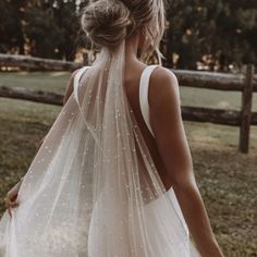 the back of a woman wearing a wedding veil