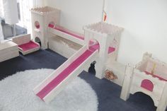 a child's bedroom with pink and white furniture, including a princess castle bed