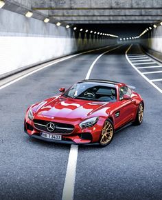 a red sports car driving through a tunnel