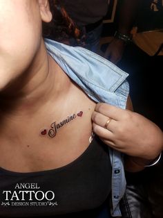 a woman with a tattoo on her chest and name written in the upper right corner