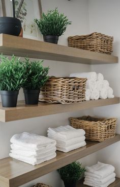 towels and plants on shelves in a bathroom