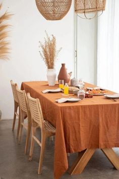 a dining table set with plates and glasses