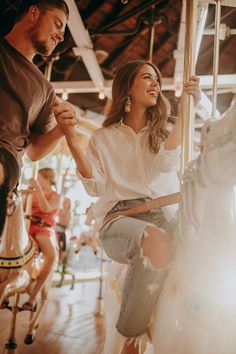 a man and woman on a merry go round ride