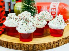 cupcakes with white frosting and sprinkles on a wooden tray