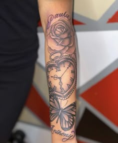 a woman with a tattoo on her arm holding a clock and a rose in the shape of a heart