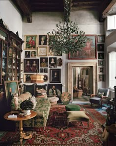 a living room filled with furniture and pictures on the wall