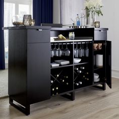 a black buffet table with wine glasses on it