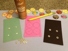 some crafting supplies are laying out on the table next to a bottle of glue