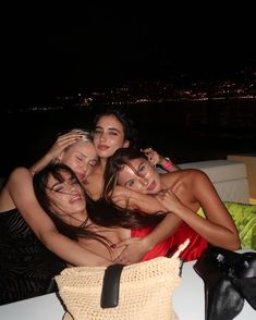 four women are posing for the camera on a boat