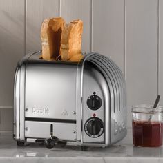 a toaster with two pieces of bread on top of it