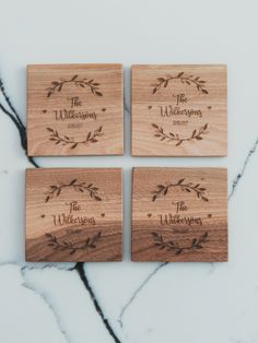 four wooden coasters with the words, the wedding and the anniversary printed on them