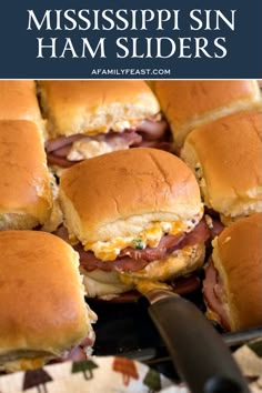 several ham sliders on a plate with a knife in the foreground and text overlay that reads, mississpii sin ham sliders