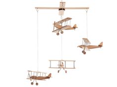 three wooden airplanes suspended from the ceiling with strings attached to each wing and one plane flying in the air