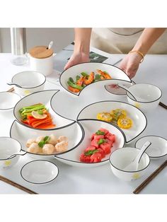 a person is placing food in bowls on a table