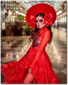 a woman in a red dress and skull makeup