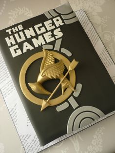 a book with a golden bird on top of it and an arrow in the middle