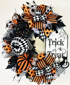 a halloween wreath with black and orange decorations