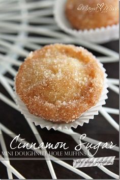 two sugary muffins sitting on top of a cooling rack with the words, cinnamon sugar mini doughnut hole muffins