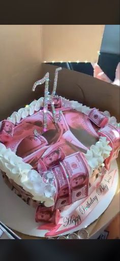 a birthday cake with money on it in a box