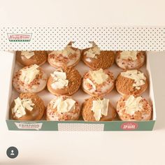 an open box of donuts with frosting and sprinkles on them